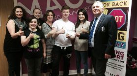 Suz, Kathy, Megan, Mary, Cailian, Charley and Ross McCrea, receiving the cheque (left - right)