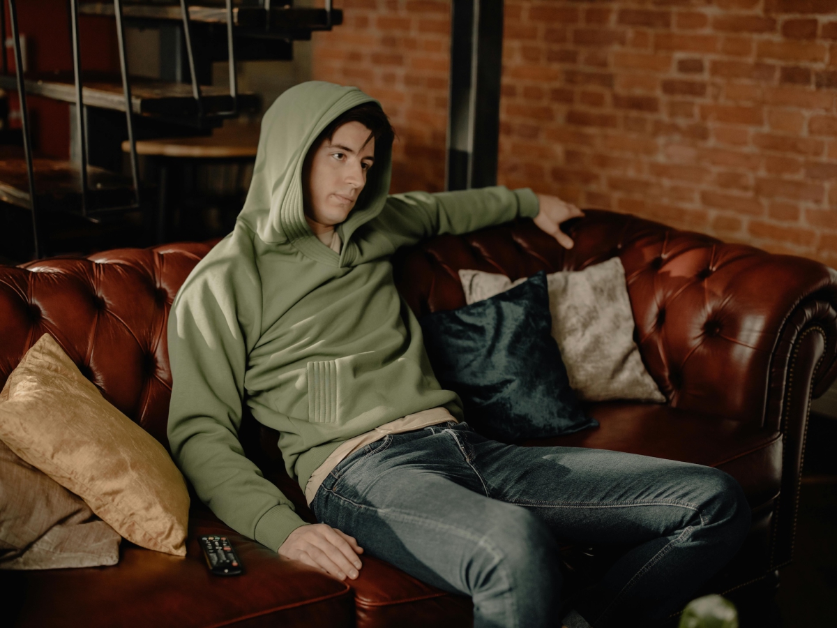 Young Man Sitting On Sofa